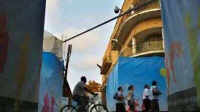 People cross the street near the UN buffer zone in divided Nicosia yesterday.