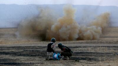 Kurdish Peshmerga fighters detonate a mine laid by ISIS south of Erbil, in northern Iraq. AFP