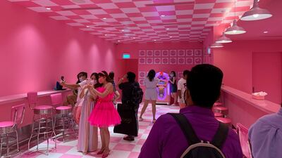 Visitors take photos in the 'Scream's Diner' at the Museum of Ice Cream in Singapore. Reuters