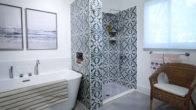 The bathroom features bold tiles