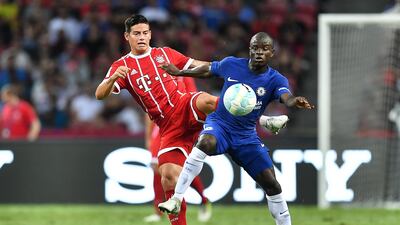 Bayern Munich's James Rodriguez and Chelsea's N'Golo Kante compete for the ball. Thananuwat Srirasant / Getty Images