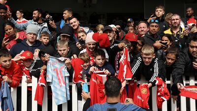 Supporters look to get an autograph from Bruno Fernandes of Manchester United. Getty Images