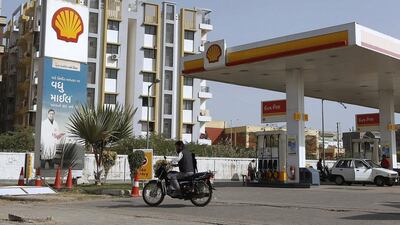 A man rides his motorcycle past a Shell fuel station on the outskirts of the western Indian city of Ahmedabad. Amit Dave / Reuters