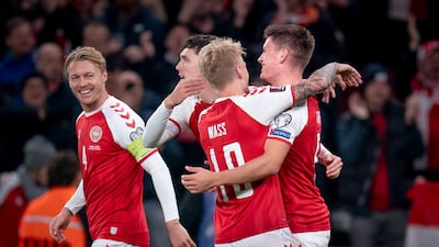 Denmark's Joakim Maehle (R) celebrates with teammates after scoring the 1-0 goal during the FIFA World Cup 2022 qualification soccer match between Denmark and Austria at Parken Stadium in Copenhagen, Denmark, 12 October 2021. EPA / Liselotte Sabroe DENMARK OUT