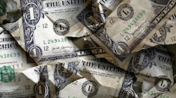 The greenback's slide means it is becoming more expensive for expatriates in countries with a currency pegged to the dollar to send money home. Getty Images