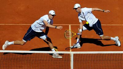 Mike Bryan and Bob Bryan, right, of the US returns the ball during their doubles tennis Davis Cup World Group semi-final against Spain's Marcell Granollers and Marc Lopez in Gijon, Spain. Eloy Alonso / Reuters