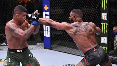 Tyron Woodley (red gloves) punches Gilbert Burns of Brazil (blue gloves) in their welterweight fight during UFC Fight Night in Las Vegas. Zuffa