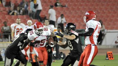 Dubai Stallions running back Davion Miller takes a carry during Friday night's Desert Bowl. Miller ran for 104 yards for the Stallions. Charles Crowell for The National / March 14, 2014