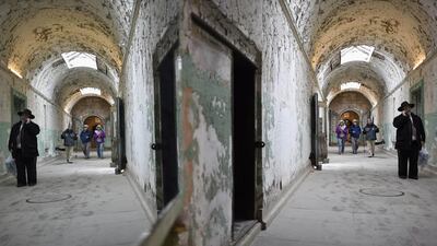 A visitor speaks on the phone in the south corridor of the closed Eastern State Penitentiary in Philadelphia, Pennsylvania. Opened in 1829, with the original corrective system of ‘confinement in solitude with labour,’ the penitentiary housed about 75,000 inmates in its 142 years of operation. Mark Makela / Reuters