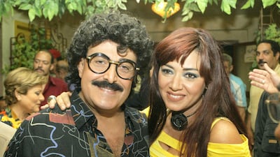 Samir Ghanem poses with actress Rania Yussef on the first day of shooting of a new TV series titled 'Maakom Al Hawa ... Hayem Abdel Dayem' in Cairo on May 21, 2006. AFP