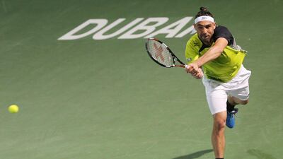 Marcos Baghdatis from Cyprus returns the ball to Feliciano Lopez from Spain during a semi final of the Dubai Tennis Championships in Dubai, United Arab Emirates, Friday, Feb. 26, 2016. (AP Photo/Kamran Jebreili)