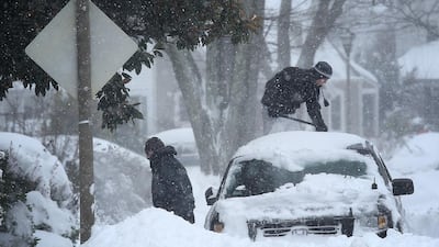 Residents clear snow from their car during a heavy snow fall in Arlington, Virginia. Heavy snow continued to fall in the Mid-Atlantic region causing ‘life-threatening blizzard conditions’ and affecting millions of people. Win McNamee / Getty Images / AFP