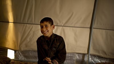 Akram Rasho Khalaf, 10, sits for a photo at the Kaabarto Camp. ‘They were telling us, ‘When you grow up, you will blow yourself up, God willing’.