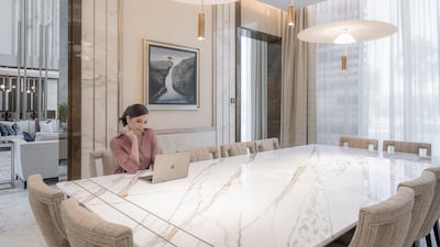 The dining table is crafted from a single slab of marble