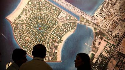 Visitors looking at the map of the Pearl Jumeirah Island at Meraas Stand at Cityscape Global 2010.