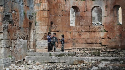 Syrian children run in the central space of the ancient Byzantine-era basilica. AFP