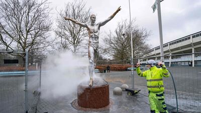 The bronze statue of football player Zlatan Ibrahimovic in Malmo, Sweden, is cleaned on Sunday, December 22, after it was vandalised again following the hometown player's decision to invest in a rival club last month. AFP