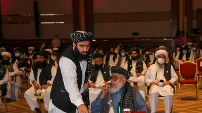Taliban negotiator Abbas Stanikzai, seated, attends the opening session of the peace talks with the Afghan government. AFP