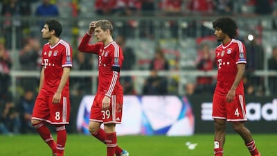 Javi Martinez, Toni Kroos and Dante of Bayern Munich look dejected after defeat in the Champions League semi-finals to Real Madrid at Allianz Arena on April 29, 2014 in Munich, Germany. Alex Grimm / Bongarts / Getty Images