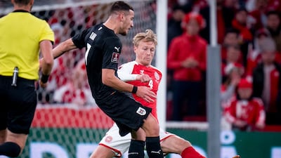 Denmark's Simon Kjaer, right, and Austria's Ercan Kara. AP