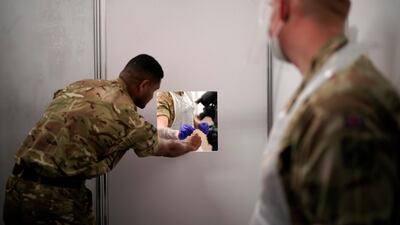 Soldiers from the Yorkshire Regiment carry out tests on each other as they prepare a mass Covid-19 testing site at Wavertree Sports Park in Liverpool. Getty Images