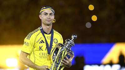 Al Nassr captain Cristiano Ronaldo poses with the Saudi Pro League trophy after a 4-1 win over Damac saw the Riyadh club crowned champions. EPA