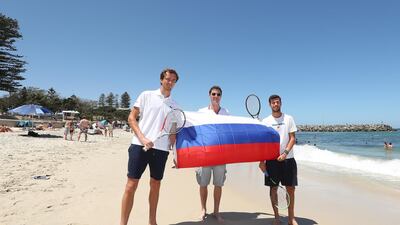Daniil Medvedev, Marat Safin and Karen Khachanov of Team Russia pose with a Russian flag during a media opportunity at Cottesloe Beach. Getty Images