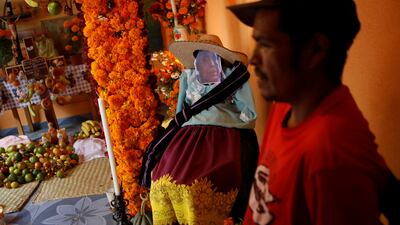 A portrait and clothes of a family member who died recently during the annual Day of the Dead celebration. Reuters
