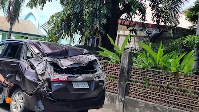A damaged car sits on a road in Bangued, Abra province, after the quake. AP
