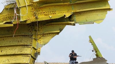 An armed rebel soldier stands guard at the main crash site of the Boeing 777 Malaysia Airlines flight MH17. Robert Ghement/EPA