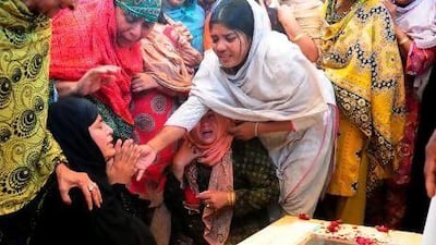 Relatives mourn next to the coffin of a passenger killed in the Bhoja Air accident, during a funeral in Karachi today.
