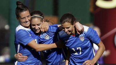 Morgan Brian, centre, celebrates with teammates Ali Krieger, left, and Tobin Heath after scoring in a friendly against New Zealand in April. Jeff Roberson / AP / April 4, 2015