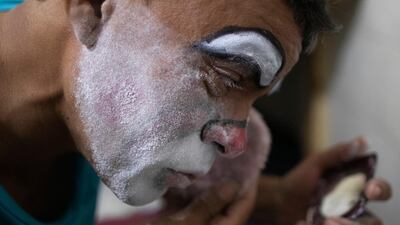 Jorge Felix Moreno powders his face with cornstarch in his hotel room in Caracas, Venezuela. AP Photo