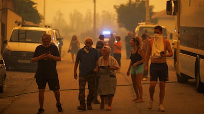 People on the streets during a fire in the village of Fradizela, in Portugal's Mirandela municipality. EPA