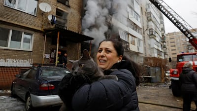 A woman with her cat, which was saved from an apartment building damaged by recent shelling in Donetsk. Reuters
