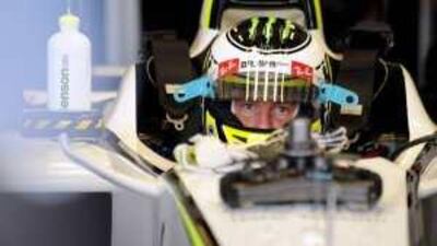 Brawn GP's British driver Jenson Button sits in his car in the pits of the Yas Marina Circuit in Abu Dhabi