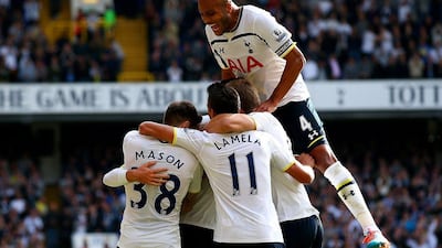 Tottenham Hotspur defender Younes Kaboul, above, jumps onto his teammates to celebrate Christian Eriksen's goal in their 1-0 win over Southampton in the Premier League on Sunday. Ian Walton / Getty Images / October 5, 2014