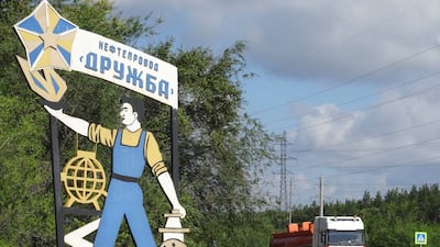 A fuel tanker passes a sign for the Druzhba oil pipeline near Samara, Russia. Reuters