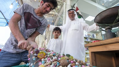 Abdulla Ali Mohsin is the owner of the Islamic Trading Est., one of the stores selling sweets and nuts for Hag Al Leila, and he stands with his grandsons in Ras Al Khaimah. Leslie Pableo / The National