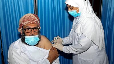 An Omani man receives a dose of the Pfizer/BioNTech Covid-19 vaccine at the Sultan Qaboos Sports Complex in Oman's capital Muscat. AFP