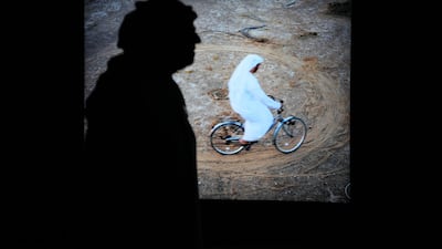 Al Attar's piece shows him riding a bicycle in a circle in five sequential images