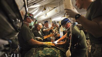 US Navy doctors attached to the Marines try to save the life of a soldier after he was injured in Helmand province, Afghanistan, 2009. Lynsey Addario / VII Network