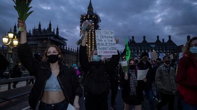 Women hold placards during a protest on Westminster Bridge. Getty Images