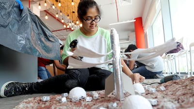 Toral Jagada with her elaborate project - complete with homes and modes of transportation - at the workshop. Chris Whiteoak / The National