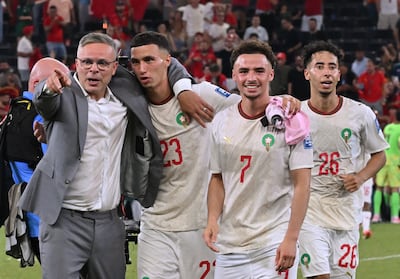 Manager Mohamed Ouahbi celebrates with Morocco players after beating the Netherlands in the Round of 32. AFP