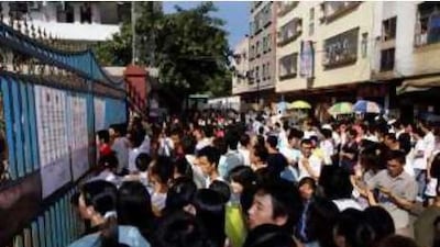 Workers gather outside a large toy factory that closed in Zhang Mu Tou of Guangdong province.