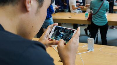 A Chinese man plays a demo VR game on the iPhone 8 Plus. Chandan Khanna / AFP Photo