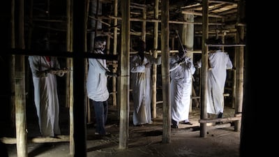 Artisans work on the reconstruction of one of the buildings.