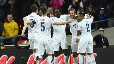 Harry Kane, third right, celebrates scoring on his England debut with teammates on March 27. Dylan Martinez / Reuters