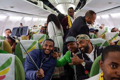 Passengers pose for a selfie inside the first commercial flight to Eritrea from Ethiopia in two decades on July 18, 2018. AFP